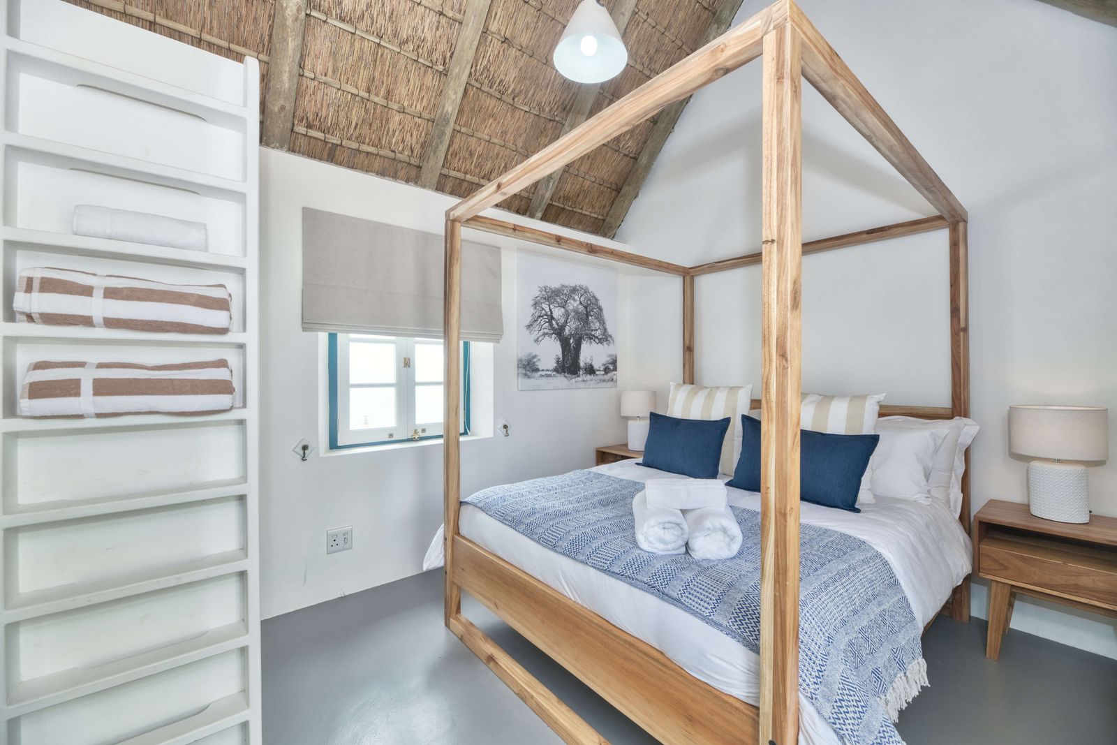The Dune Cottage at Cape Creek Retreat, a queen four-poster under thatch